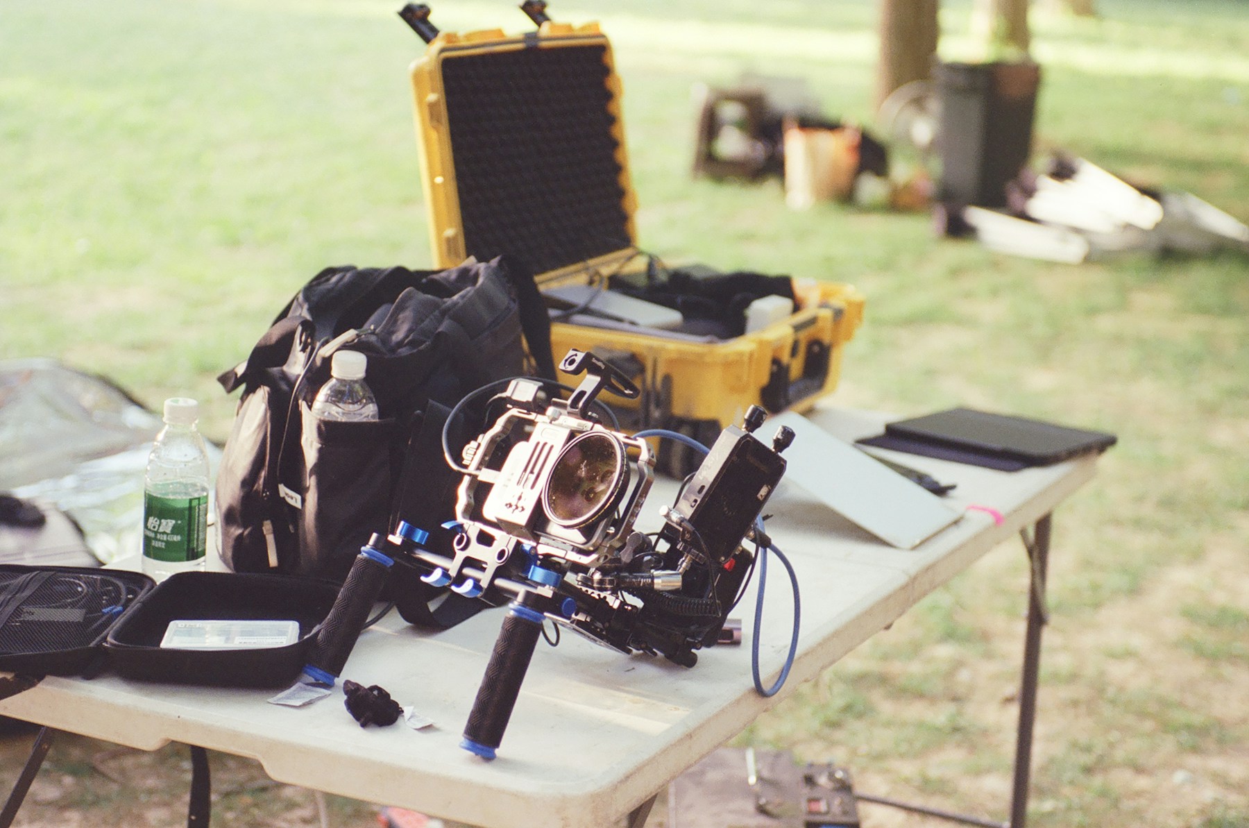 Professional camera equipment on an outdoor table in daylight